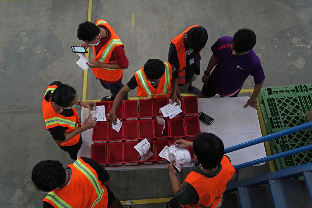 Workers check orders at a Titipaja fulfillment center in Jakarta, Indonesia (Dimas Ardian/Bloomberg via Getty Images)