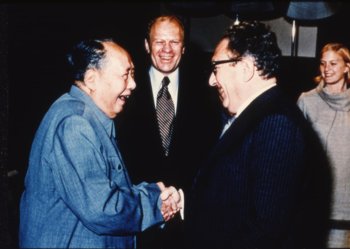 US President Gerald Ford and daughter Susan watch as Secretary of State Henry Kissinger, right, shakes hands with Mao Tse-Tung (US National Archives 7062596/A7912)