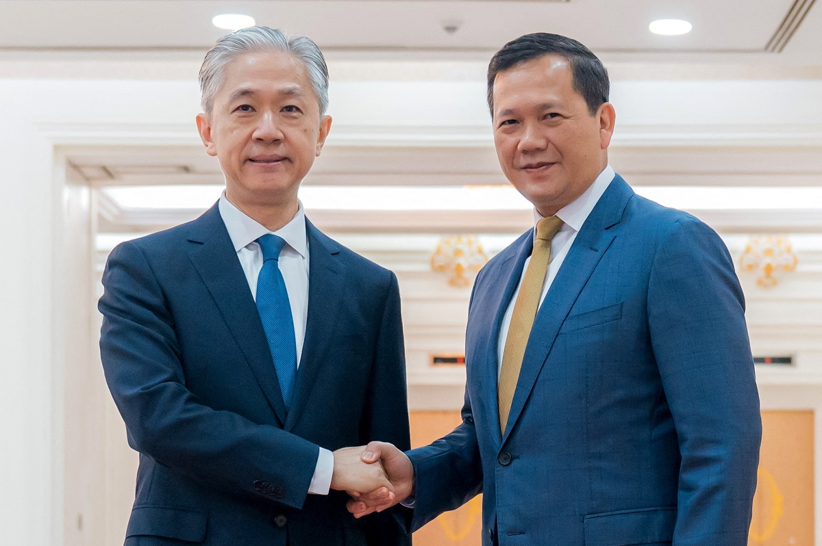 Cambodia's Prime Minister Hun Manet (R) with China's new Ambassador to Cambodia Wang Wenbin (L) during a meeting at the Peace Palace in Phnom Penh on 22 July 2024 (STR/Pool/AFP via Getty Images)