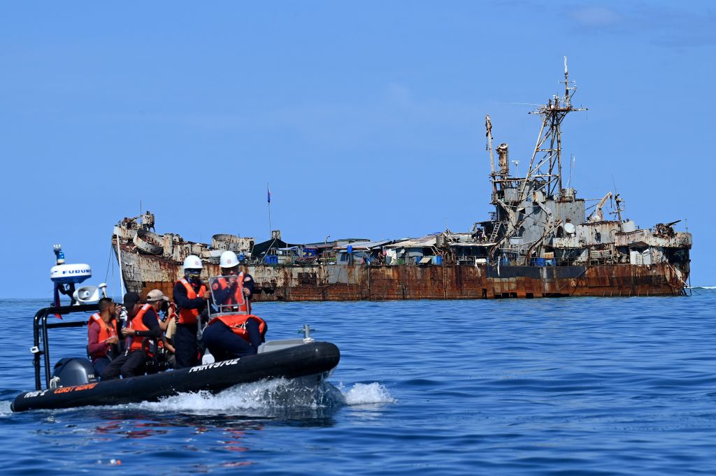 Philippine coast guard personnel and journalists returning to another shop after filming the BRP Sierra Madre at Second Thomas Shoal (Jam Sta Rosa/AFP via Getty Images)