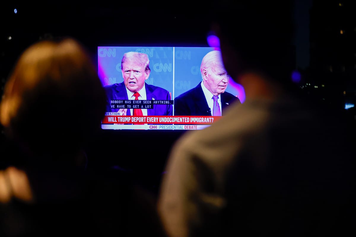 New Yorkers watching the 2024 Presidential Debate between Trump and Biden on 27 June (Lokman Vural Elibol/Anadolu via Getty Images)