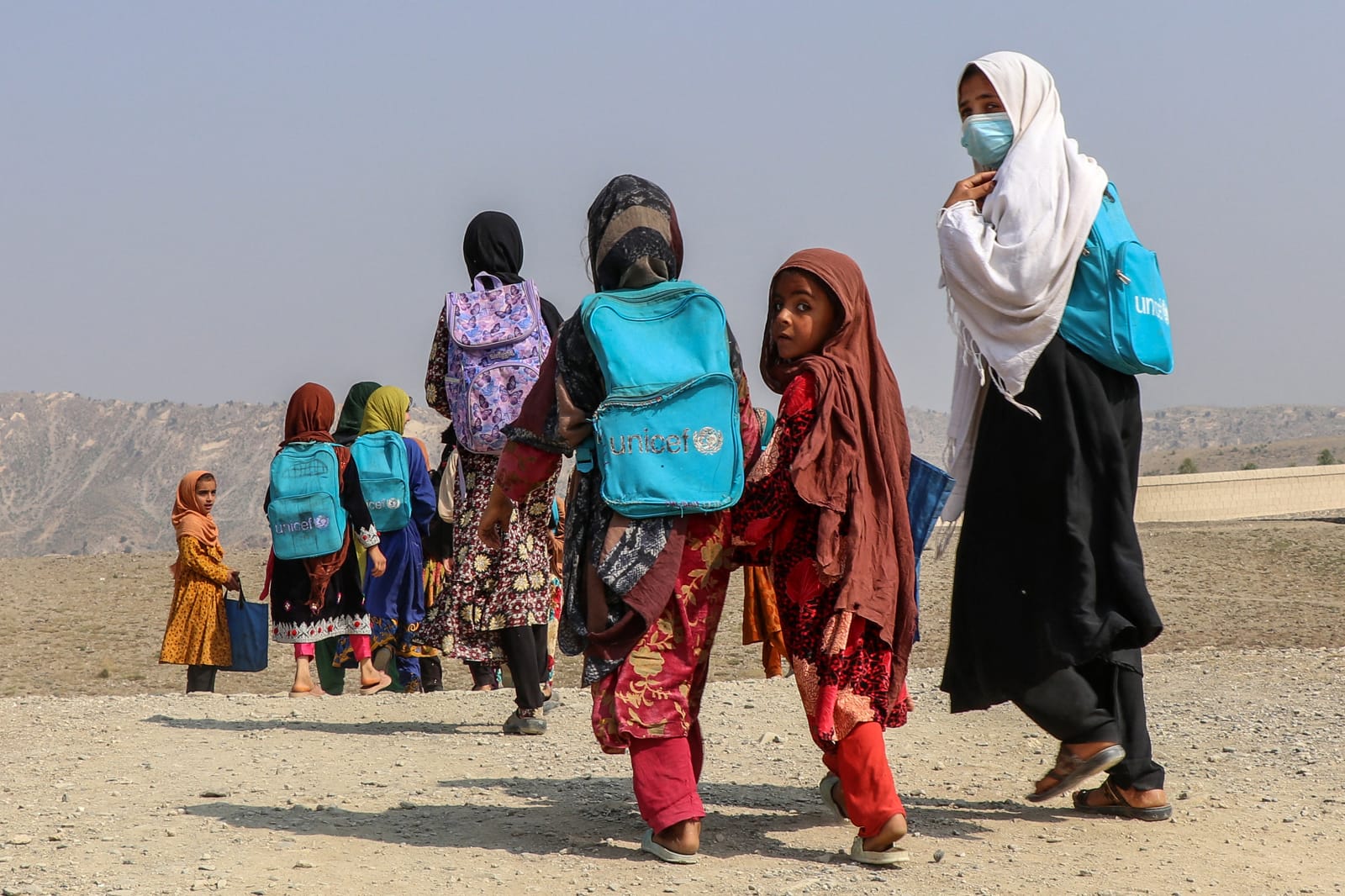 Afghan school girls walk back to their homes along a path in Khost, 21 October 2024 (AFP via Getty Images)