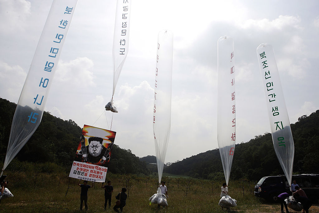 North Korean defectors, living in South Korea, release balloons to float across the border carrying propaganda leaflets denouncing the regime in Pyongyang in 2016 (Chung Sung-Jun/Getty Images)