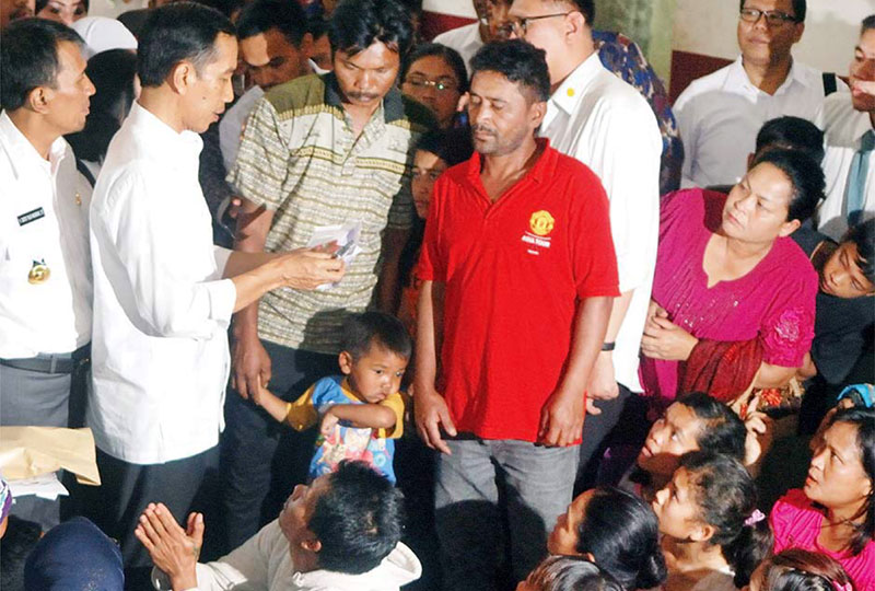 Then Indonesian president Joko Widodo delivers the Prosperous Family Card for cash transfers in 2014 (Jakarta Post)