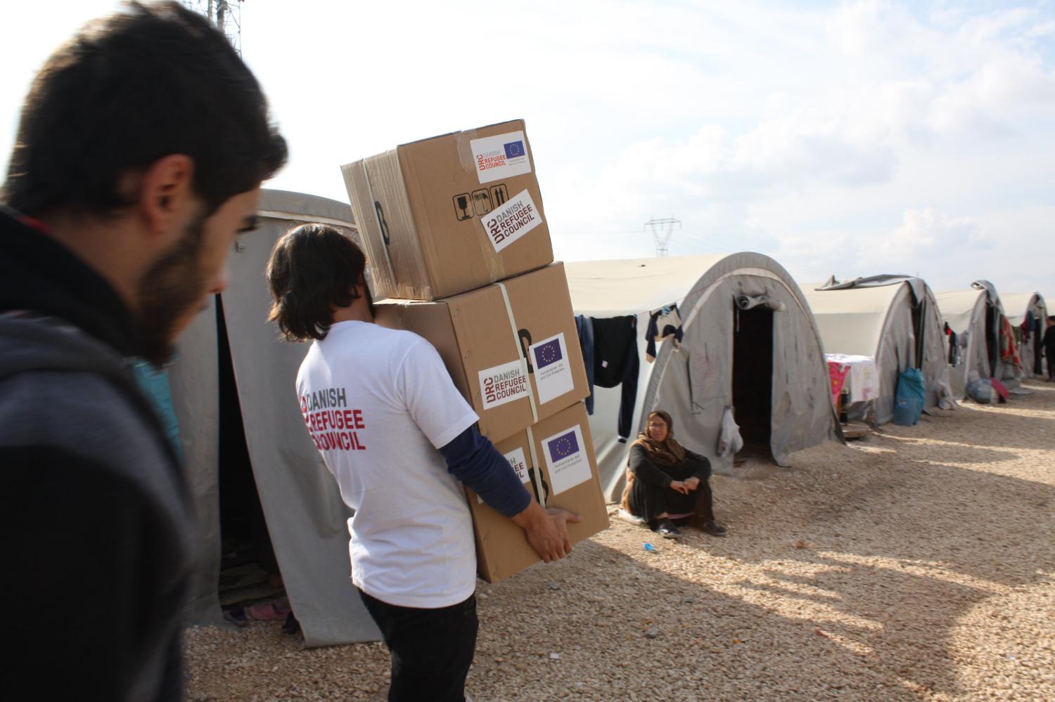 Families at a Syrian refugee camp in Turkey receive relief supplies from the Danish Refugee Council. (Flickr/European Union)