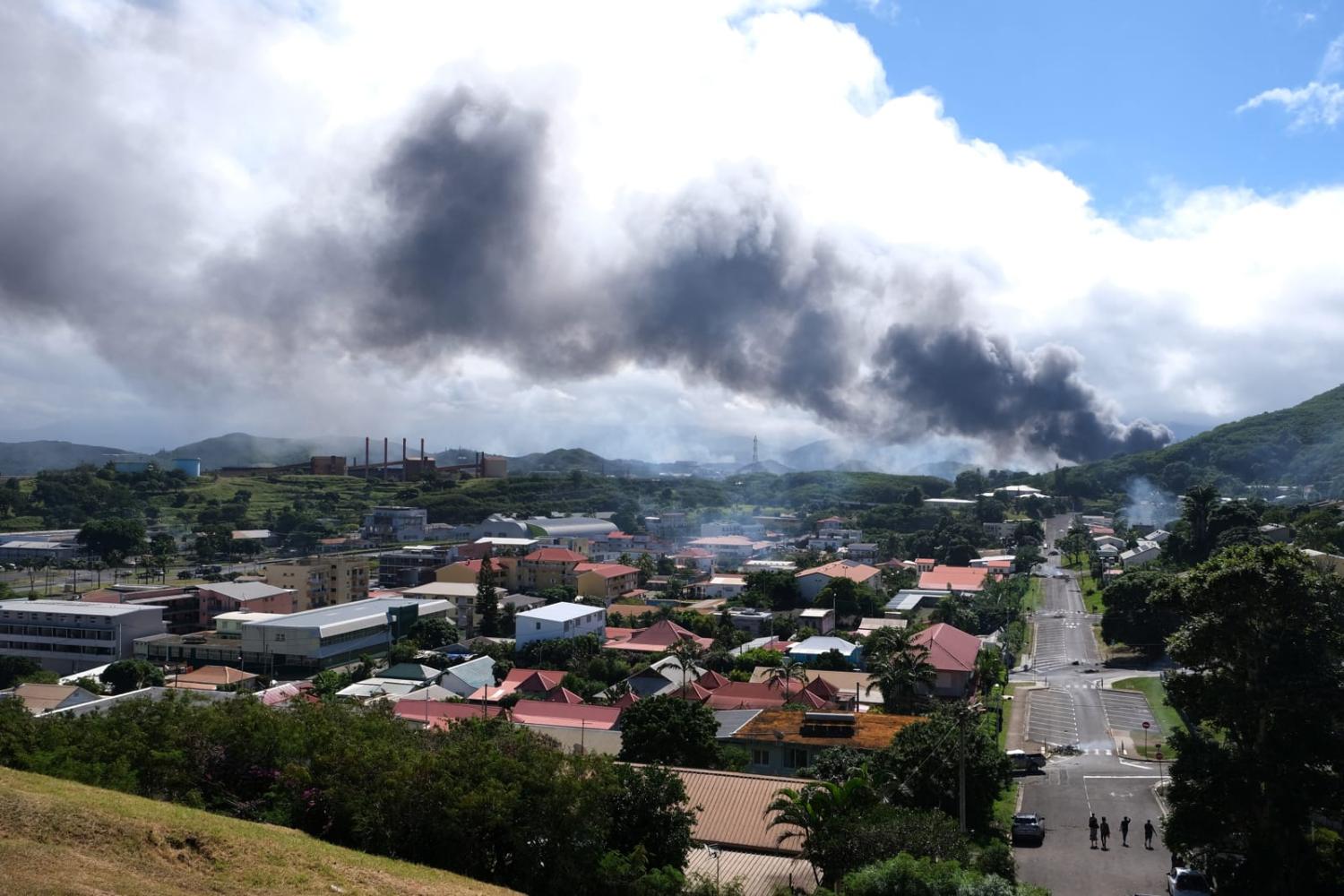 Smoke rising above Noumea as demonstrations turned violent over a proposal to enlarge the electorate for upcoming elections of the overseas French territory of New Caledonia (Theo Rouby/AFP via Getty Images)