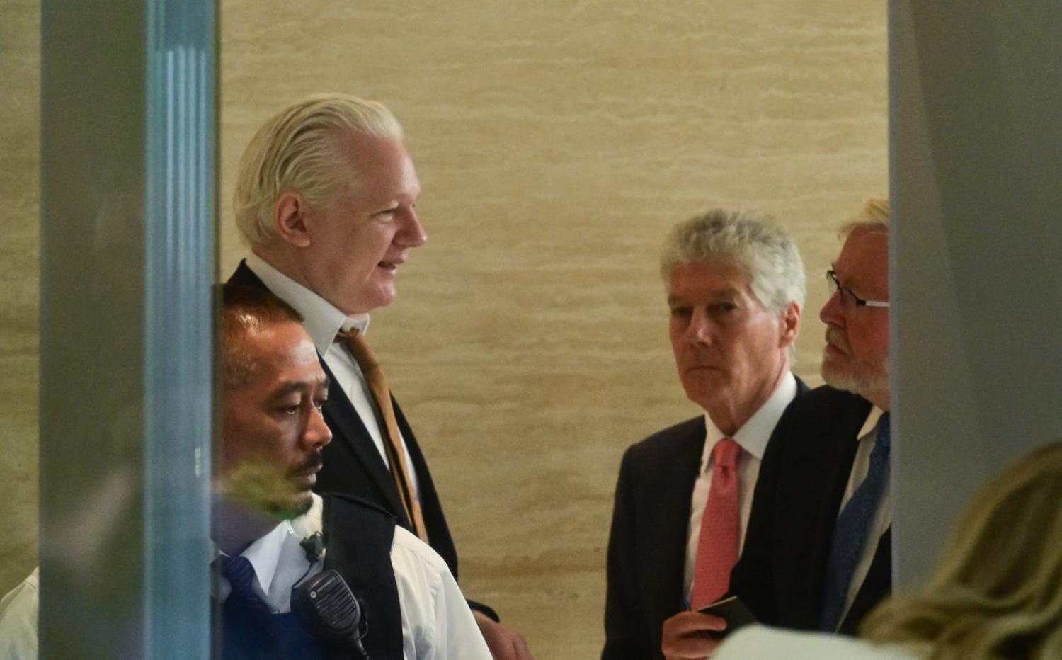 WikiLeaks founder Julian Assange, left, speaking with Australian ambassador to the US Kevin Rudd and Australian High Commissioner to the United Kingdom Stephen Smith outside a court in Saipan, Northern Mariana Islands (Yuichi Yamazaki/AFP via Getty)