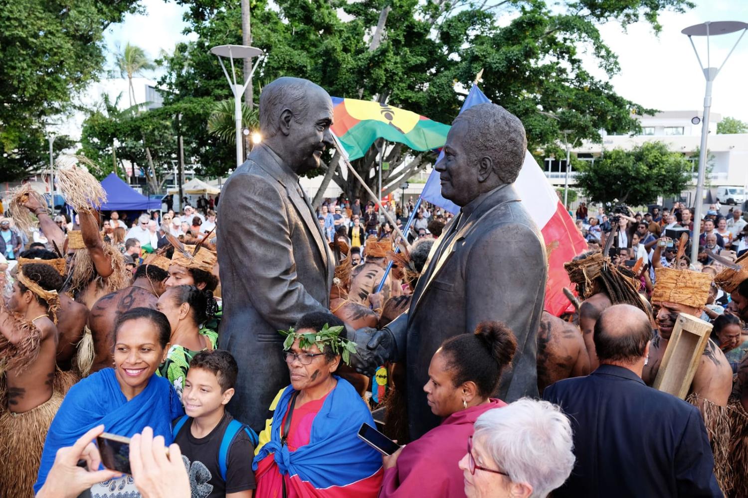 A 2022 gathering in Noumea around a statue representing the 1988 peace agreement in New Caledonia (Theo Rouby/AFP via Getty Images)