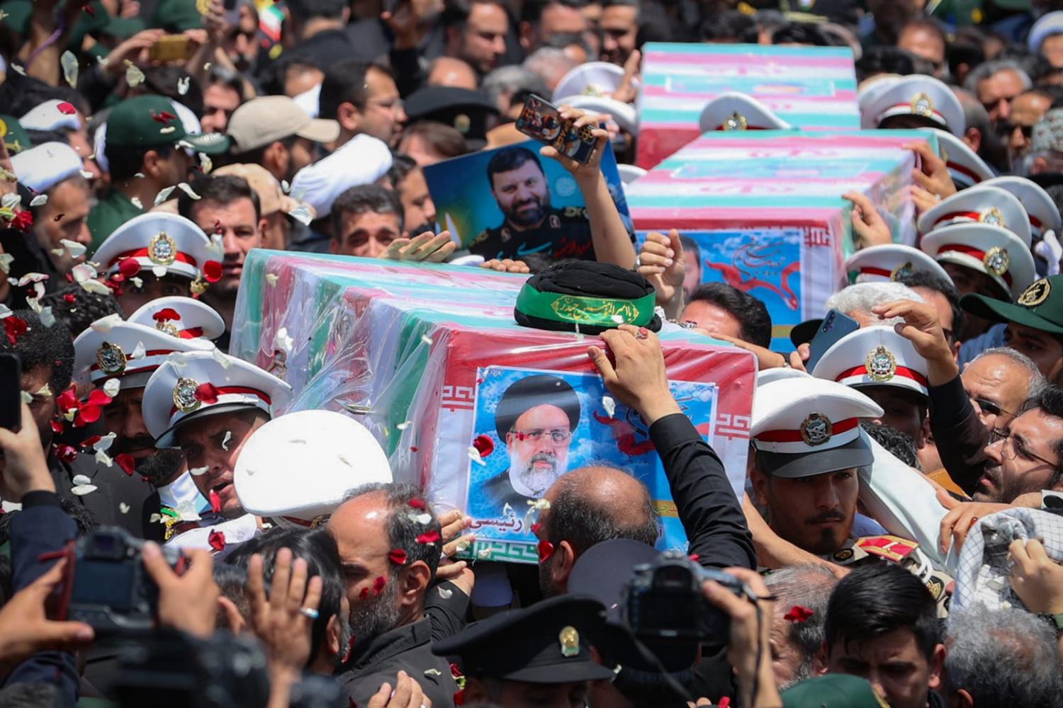 Soldiers carry the caskets of Iranian President Ebrahim Raisi and two other officials killed in a helicopter crash in a funeral procession, Birjand, Iran, 23 May 2024 (Office of the President of the Islamic Republic of Iran via Getty Images)