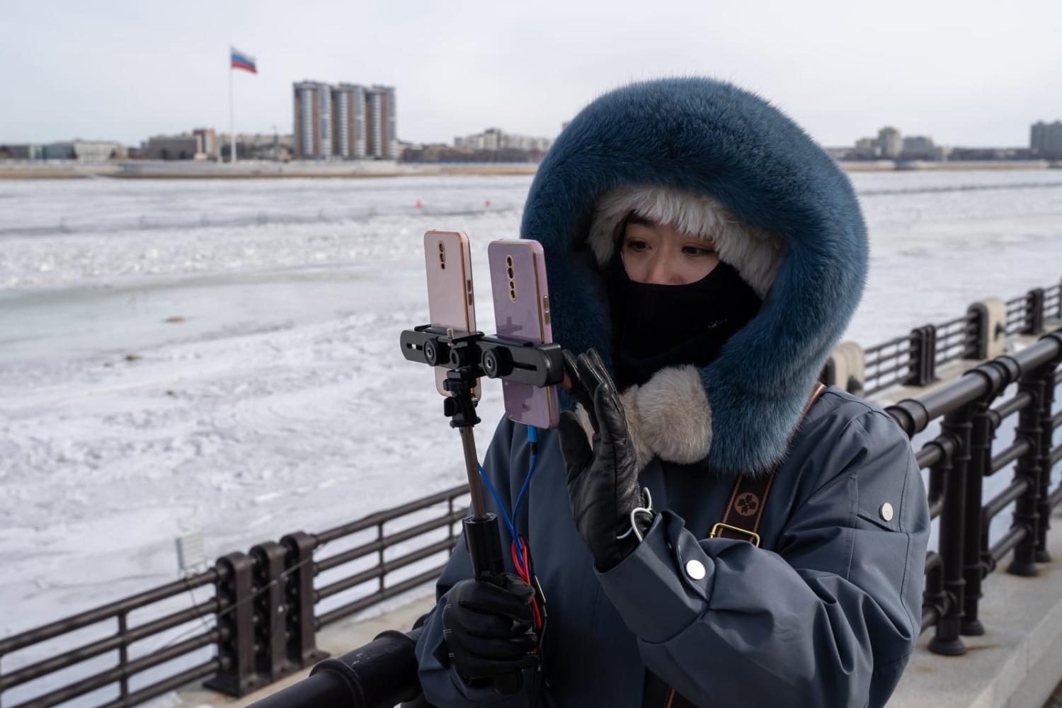 China has sought to fill the cultural hole in Russia from the break with Europe: Livestreaming by the China-Russia border, the Russian city of Blagoveshchensk behind, in Heihe, Heilongjiang Province, China (Anadolu Agency via Getty Images)