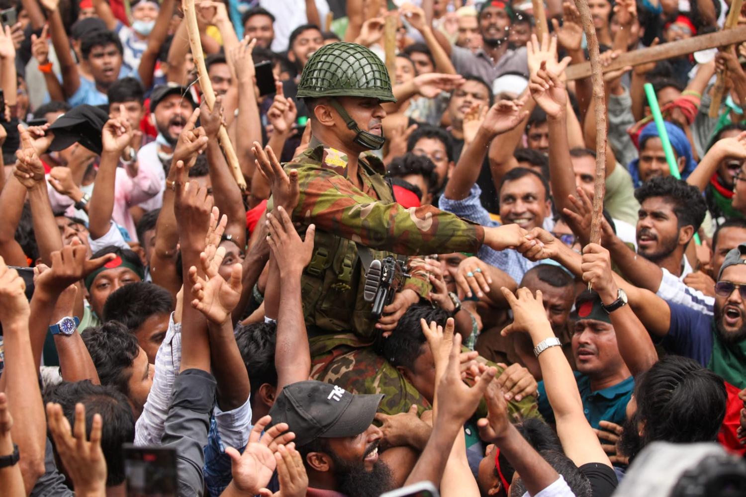 Anti-government protestors celebrate in Dhaka on 5 August after Prime Minister Sheikh Hasina fled the country and the military announced it would form an interim government (Abu Sufian Jewel via Getty Images)