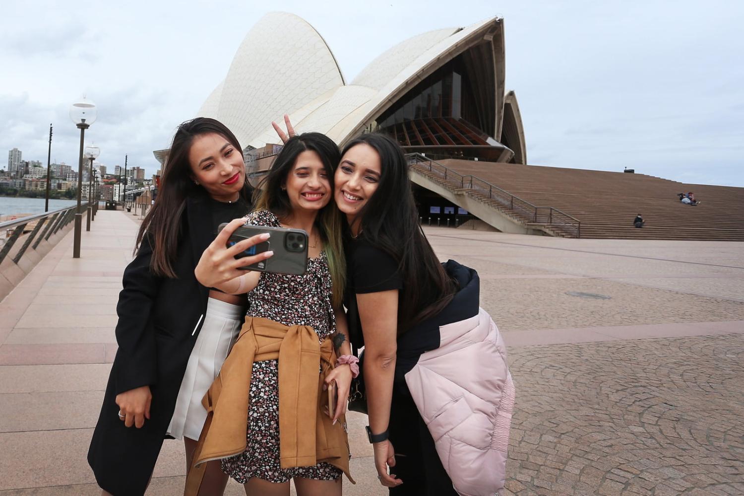 International students in Sydney after Australia relaxed its Covid-19 lockdown rules, 12 October 2021  (Lisa Maree Williams/Getty Images)