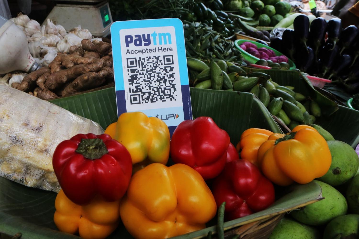 A vegetable vendor displays a QR code for mobile phone-based digital payment (Debajyoti Chakraborty/NurPhoto via Getty Images)