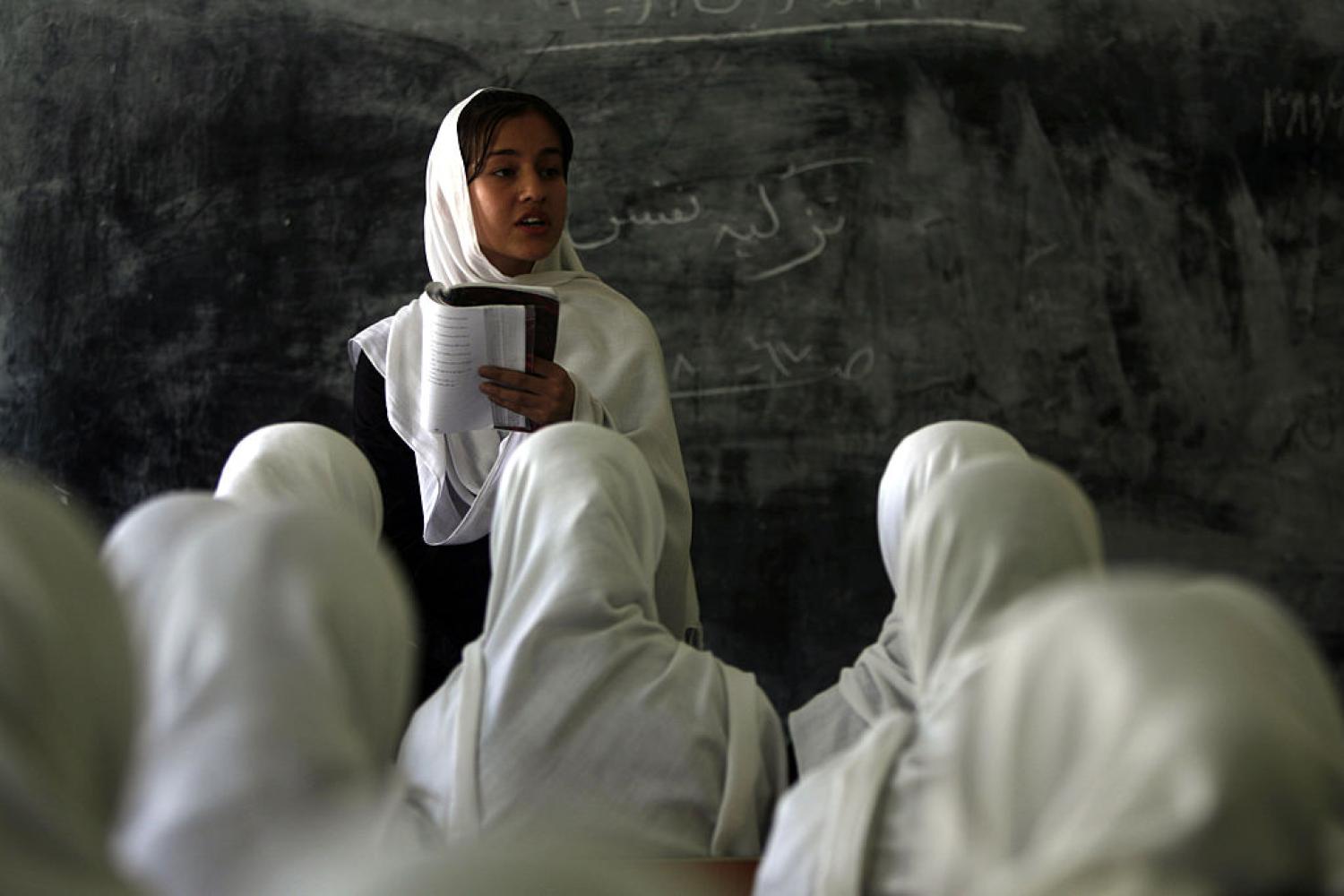 A student reads a poem at a girls school in Kabul in 2010. The Taliban have again banned female education and work and now reading poetry (Patrick Baz/AFP via Getty Images)