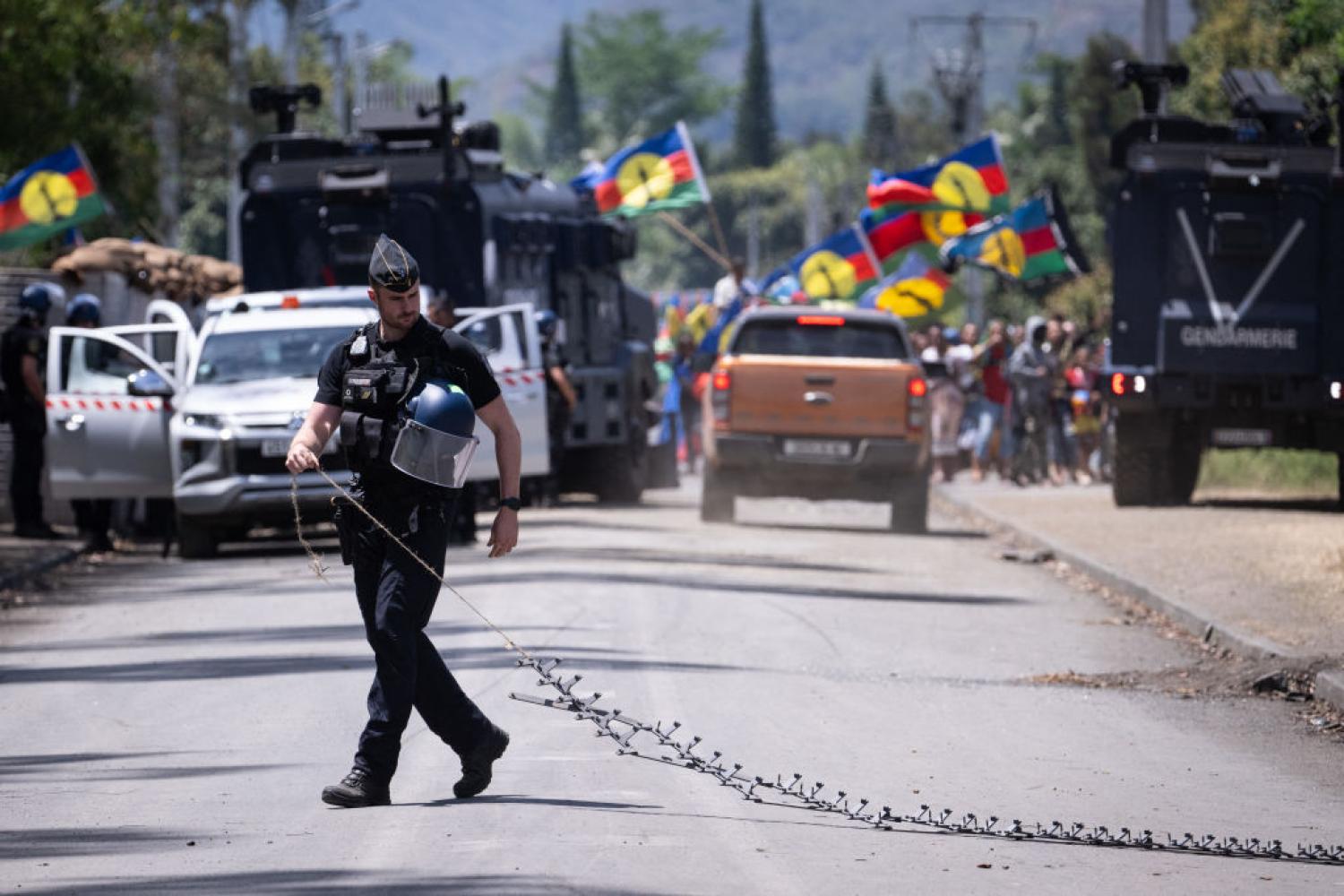 A French gendarme at a processions to return bodies to the Saint-Louis tribe in Noumea, New-Caledonia, on 28 September 2024. Two local residents were killed in the course of a Gendarmerie operation on 19 September. (Sebastien Bozon/Getty)