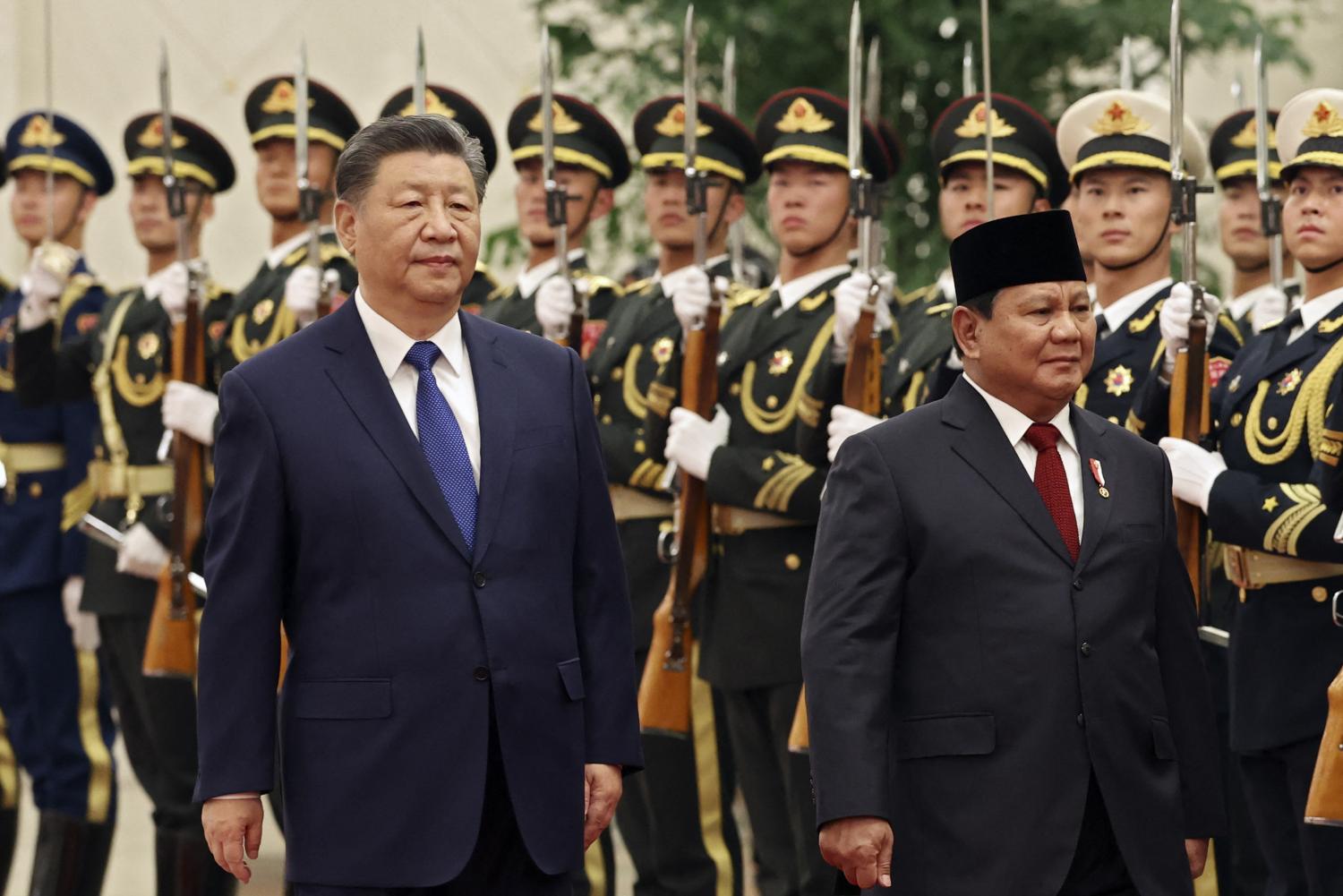 Chinese President Xi Jinping (L) and Indonesian President Prabowo Subianto review the honour guard during a welcome ceremony at the Great Hall of the People in Beijing on November 9, 2024. (Florence Lo/Getty)