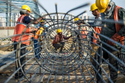 Workers build the foundation for a new electronics factory in Noida, India, 22 March 2024 (Prashanth Vishwanathan/Bloomberg via Getty Images)