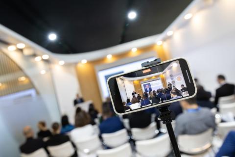 A mobile phone camera recording proceedings at the Azerbaijan Pavilion during COP29 (Kiara Worth/UN Climate Change)