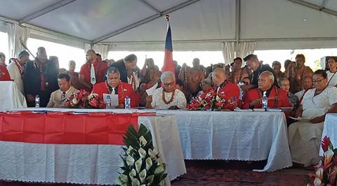 Fiame Naomi Mata’afa (seated centre, in white) with members of parliament and the judiciary in Apia on 24 May as she is sworn in as Samoa’s first woman prime minister in a makeshift ceremony outside parliament (Malietau Malietoa/AFP via Getty Images)